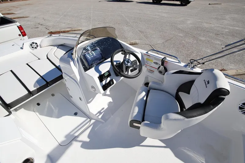 Slide: The Image of 2025 Stingray 192 SC boat interior with steering wheel and seating. - 12