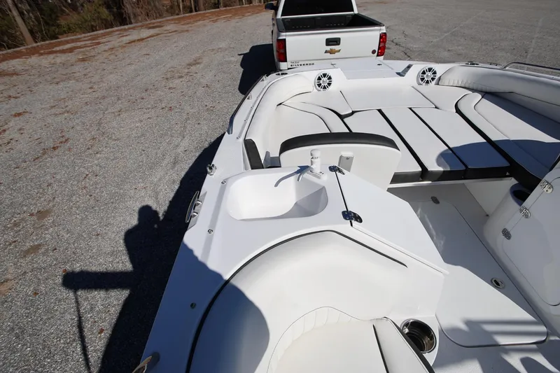 Slide: The Image of 2025 Stingray 192 SC boat interior with seating, parked near a Chevrolet Silverado truck. - 14