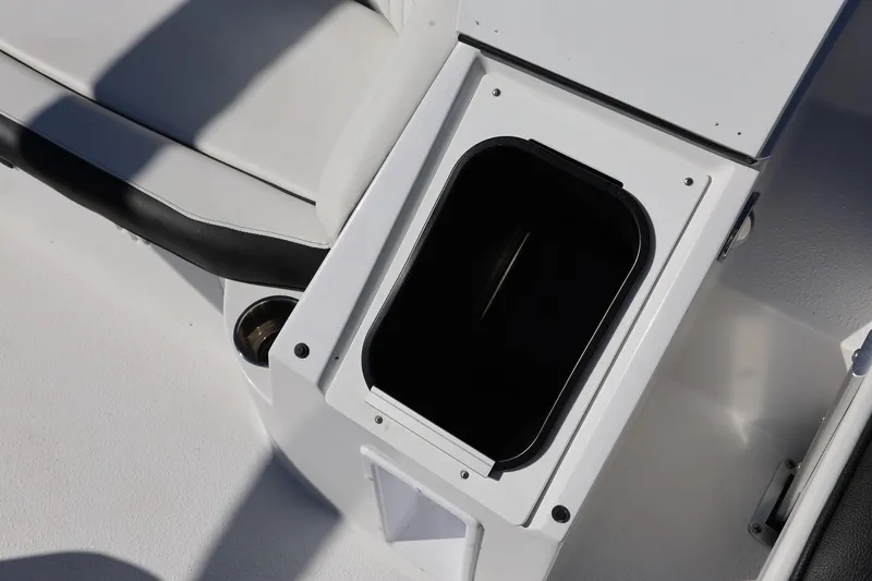 Slide: The Image of 2025 Stingray 192 SC boat interior storage compartment with cup holder. - 17