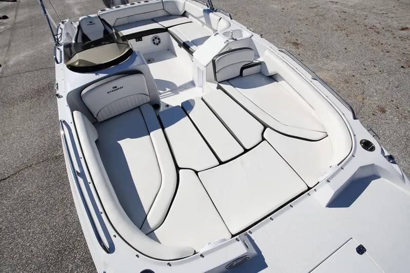 Slide: The Image of 2025 Stingray 192 SC boat interior with spacious white seating and sleek design. - 19