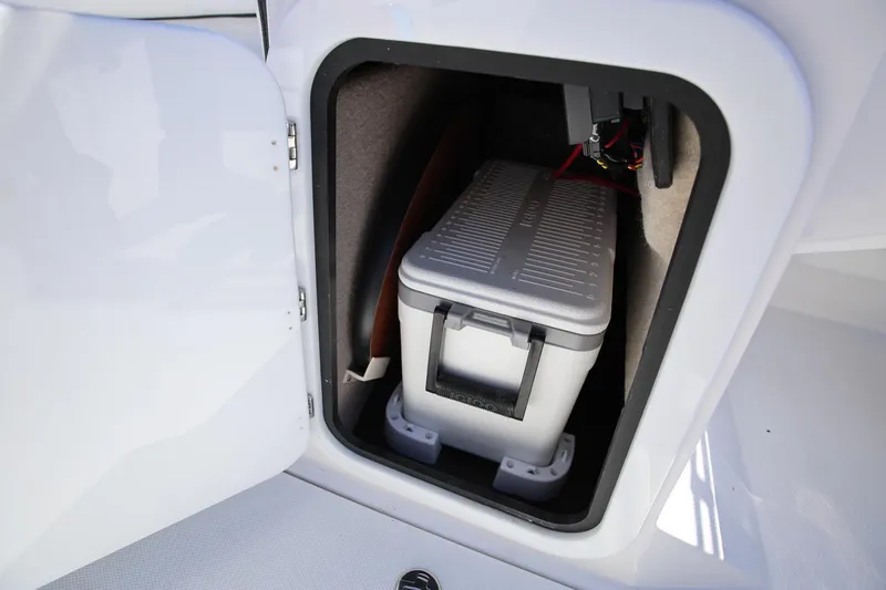 Slide: The Image of Storage compartment in 2025 Stingray 192 SC boat with cooler inside. - 20