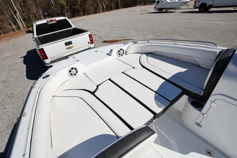 Slide: The Image of 2025 Stingray 192 SC boat interior with white seating, parked near a Chevrolet Silverado. - 21