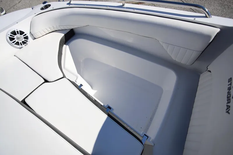 Slide: The Image of Interior seating of 2025 Stingray 192 SC boat, featuring white cushioned seats. - 23
