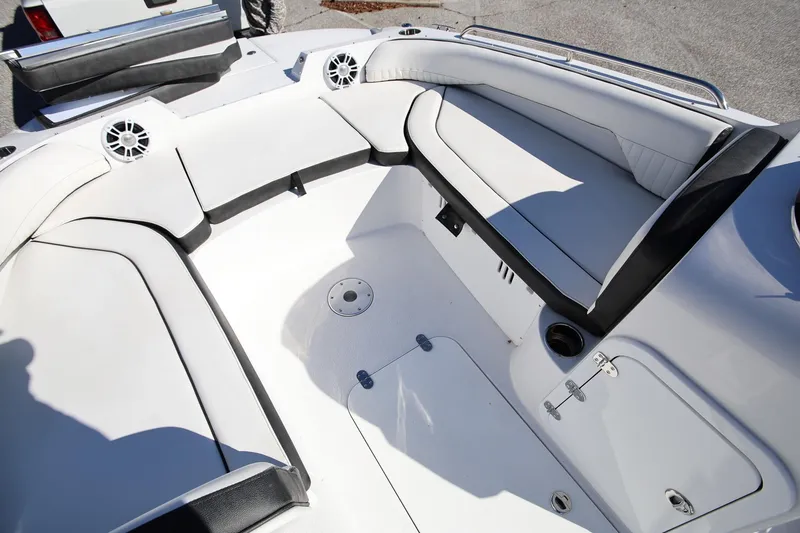 Slide: The Image of 2025 Stingray 192 SC boat interior with white seating and built-in speakers. - 24