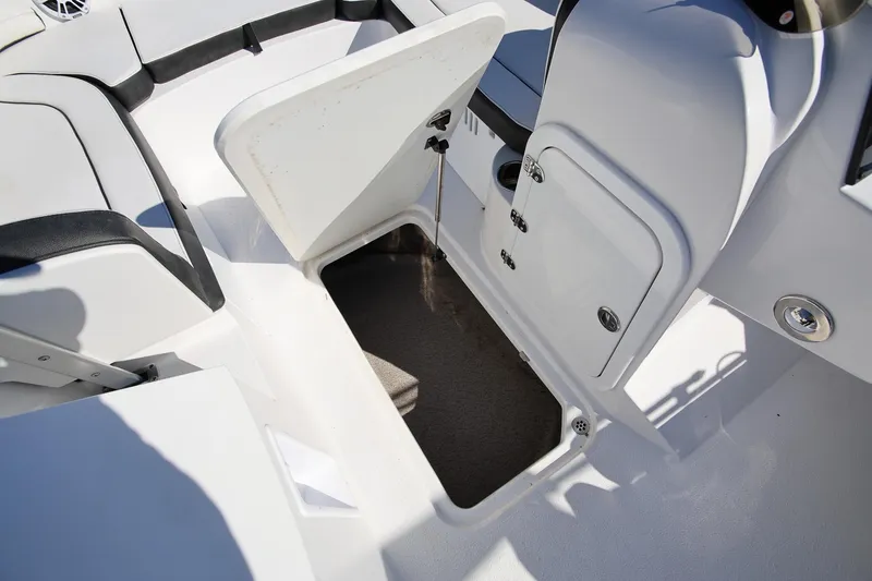 Slide: The Image of 2025 Stingray 192 SC boat interior storage compartment with open hatch. - 25
