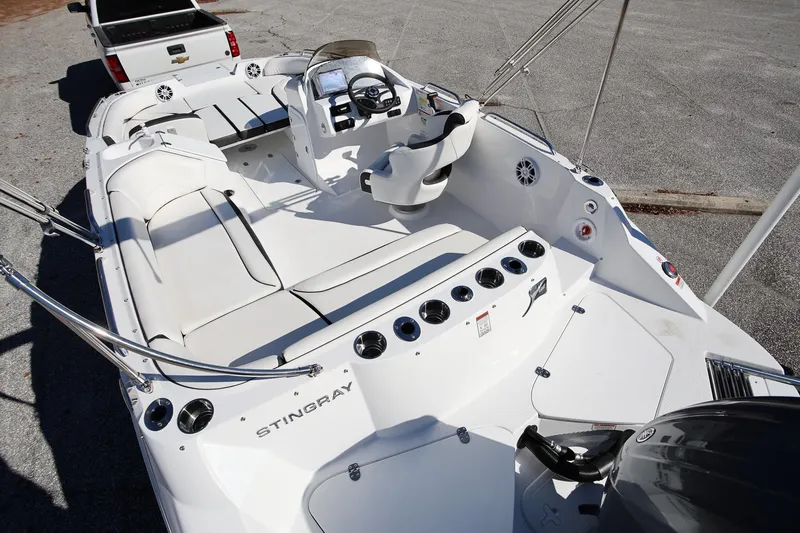 Slide: The Image of 2025 Stingray 192 SC boat interior with seating and steering console. - 6