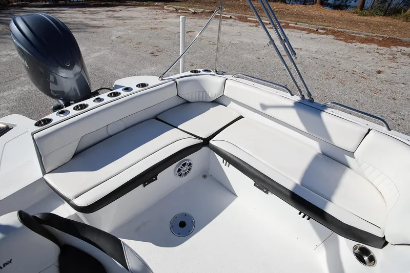 Slide: The Image of 2025 Stingray 192 SC boat interior with white seating and cup holders. - 8