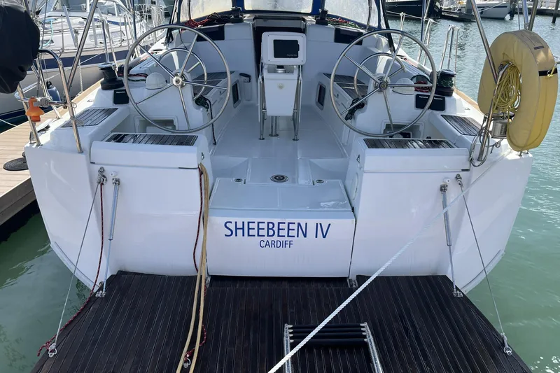 Slide: The Image of 2017 Jeanneau Sun Odyssey 419 sailboat docked, featuring dual steering wheels and "SHEEBEEN IV" name. - 11