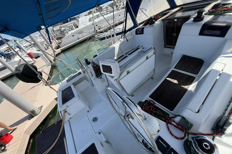 Slide: The Image of 2017 Jeanneau Sun Odyssey 419 sailboat cockpit with dual steering wheels at marina. - 18