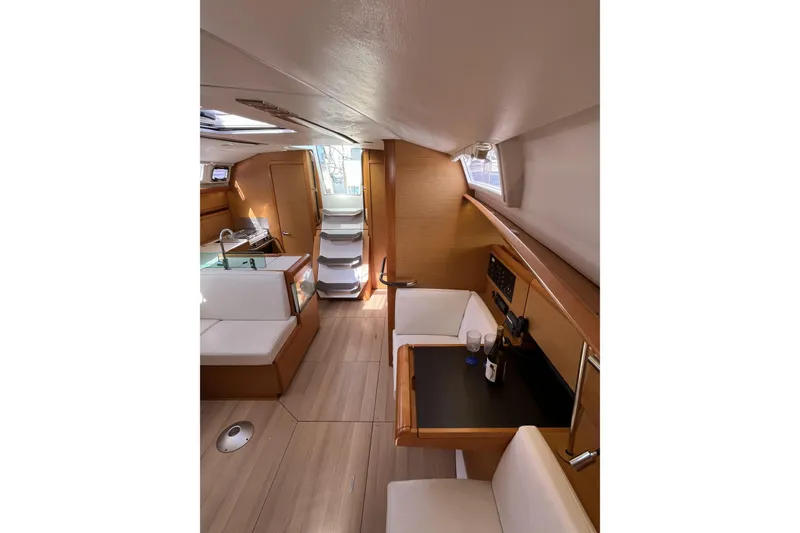 Slide: The Image of Interior of 2017 Jeanneau Sun Odyssey 419 yacht, featuring modern seating and dining area. - 21