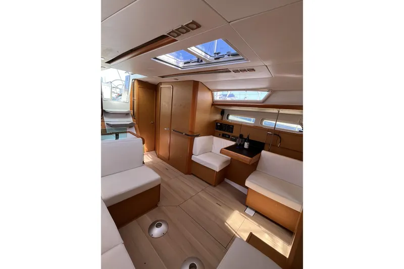 Slide: The Image of Interior of 2017 Jeanneau Sun Odyssey 419 sailboat, featuring modern wood finish and seating. - 22
