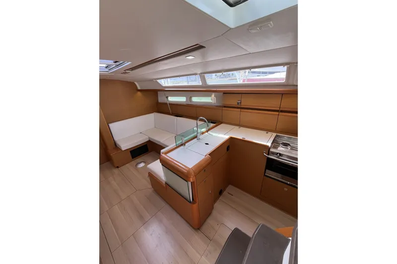 Slide: The Image of Interior of 2017 Jeanneau Sun Odyssey 419 yacht with modern kitchen and seating area. - 24