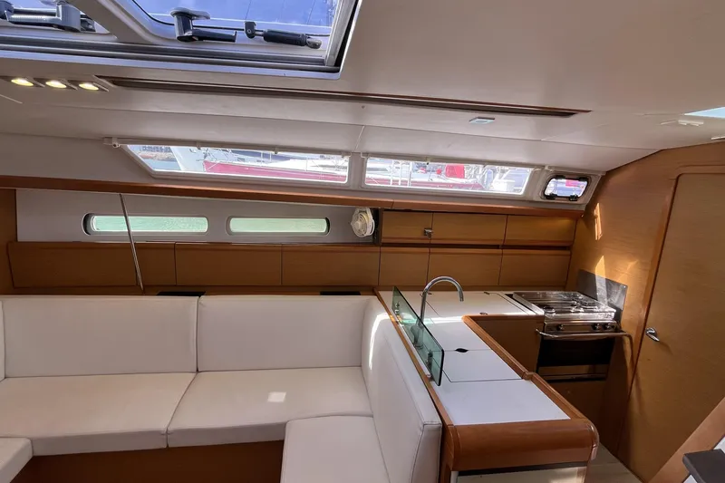 Slide: The Image of Interior of 2017 Jeanneau Sun Odyssey 419 yacht, featuring modern kitchen and seating area. - 27