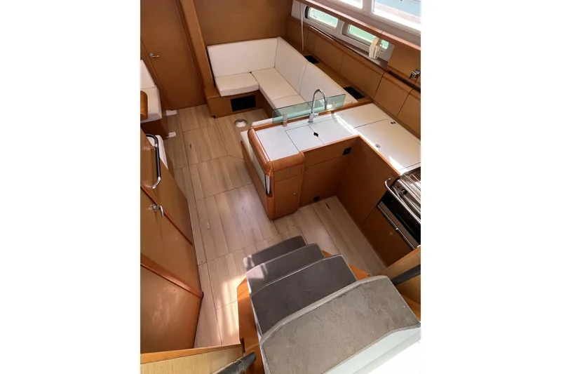 Slide: The Image of Interior of 2017 Jeanneau Sun Odyssey 419 yacht, featuring modern kitchen and seating area. - 28