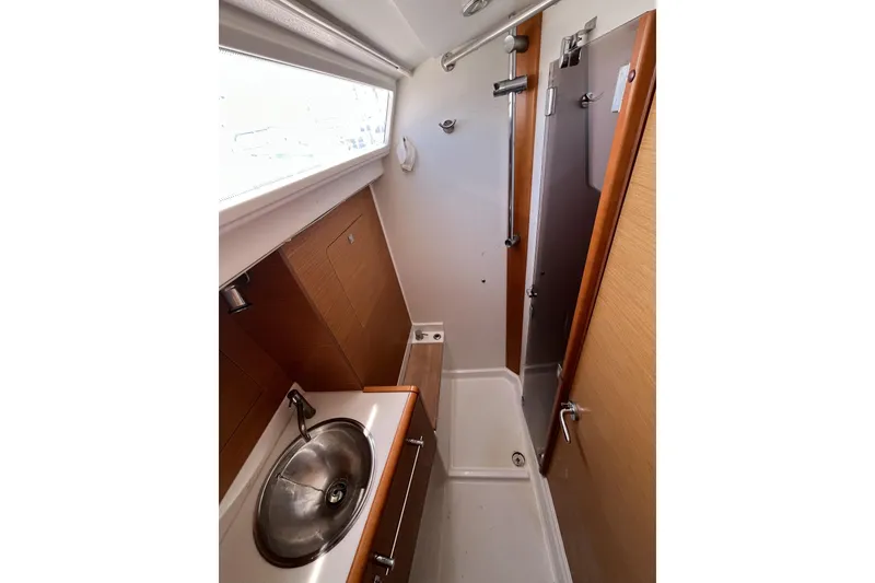 Slide: The Image of 2017 Jeanneau Sun Odyssey 419 bathroom with sink, shower, and wooden cabinetry. - 32