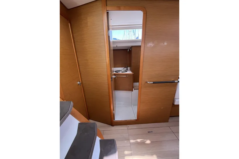 Slide: The Image of Interior of 2017 Jeanneau Sun Odyssey 419 sailboat, featuring wooden cabinetry and compact bathroom. - 34