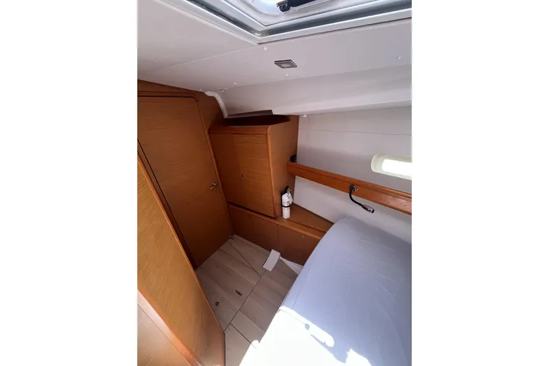 Slide: The Image of Interior cabin of 2017 Jeanneau Sun Odyssey 419 sailboat, featuring wood paneling and natural light. - 39