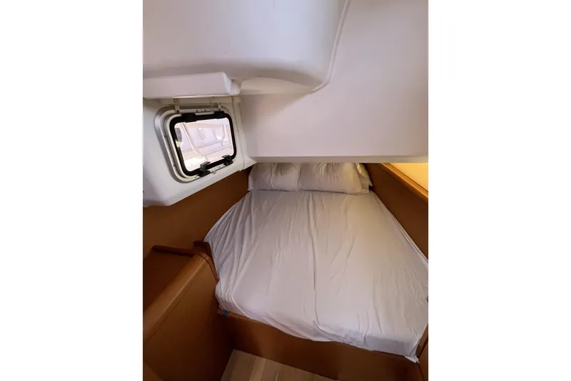 Slide: The Image of Cozy cabin interior of 2017 Jeanneau Sun Odyssey 419 sailboat with bed and window. - 40