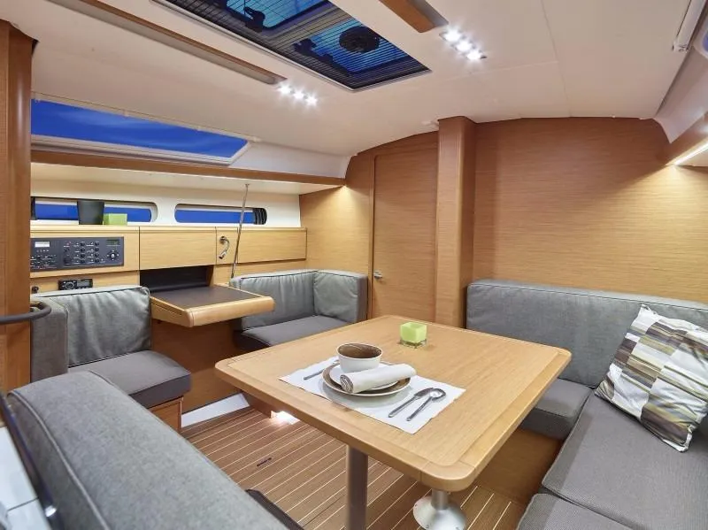 Slide: The Image of Manufacturer Provided Image: Interior of 2017 Jeanneau Sun Odyssey 419 sailboat with dining area and modern furnishings. - 5