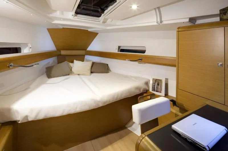 Slide: The Image of Manufacturer Provided Image: 2017 Jeanneau Sun Odyssey 419 interior cabin with bed, desk, and storage. - 7