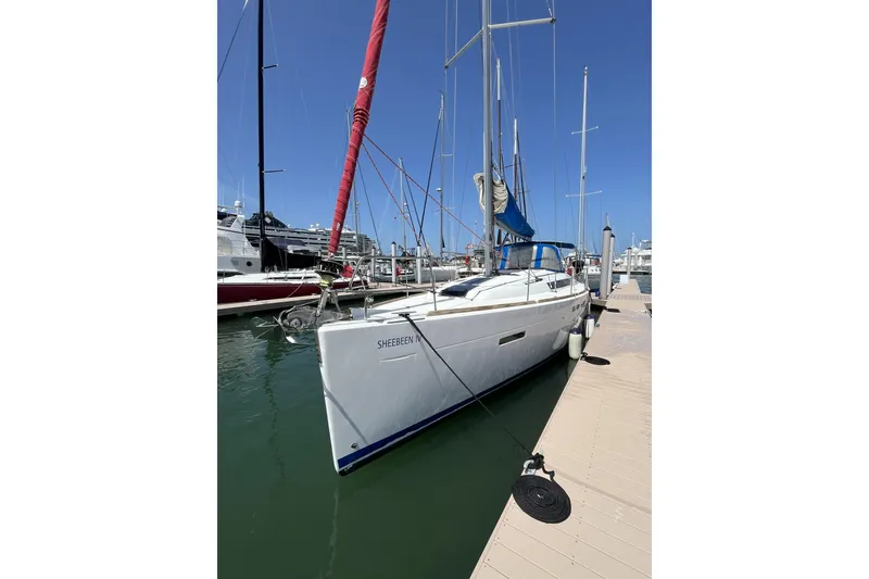 Slide: The Image of 2017 Jeanneau Sun Odyssey 419 sailboat docked at marina under clear blue sky. - 9