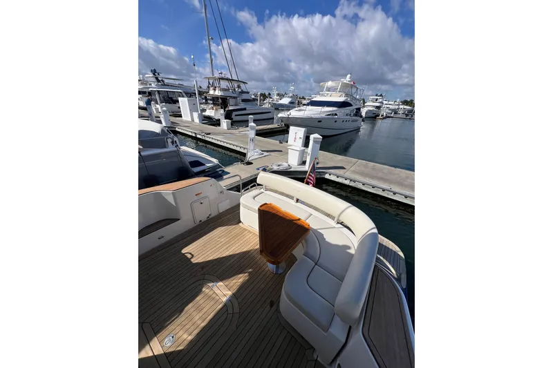 Slide: The Image of 2007 Chris-Craft Roamer 40 yacht docked, showcasing sleek design and clear windows. - 10