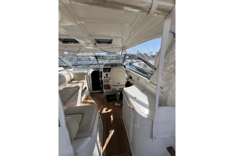 Slide: The Image of 2007 Chris-Craft Roamer 40 yacht docked in marina, featuring sleek design and clear canopy. - 11