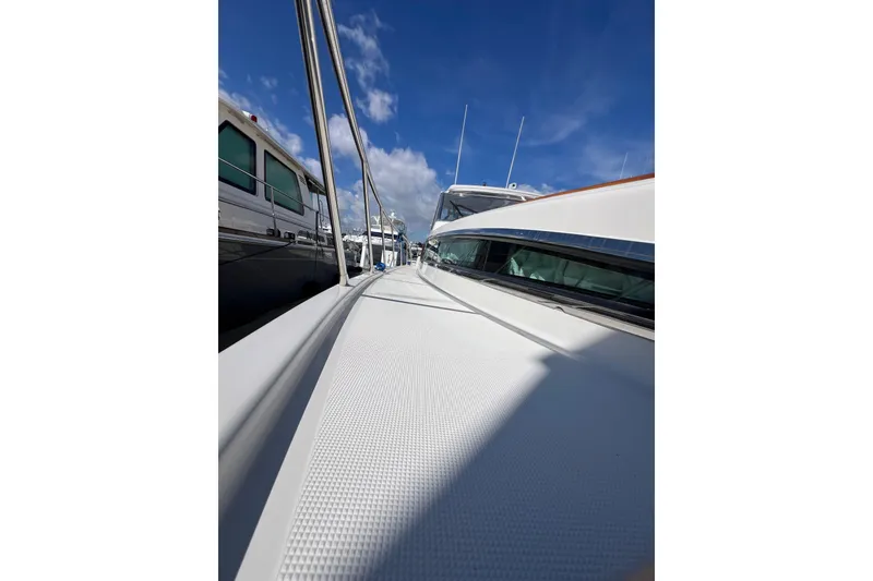 Slide: The Image of 2007 Chris-Craft Roamer 40 yacht docked, showcasing sleek design and spacious deck. - 23