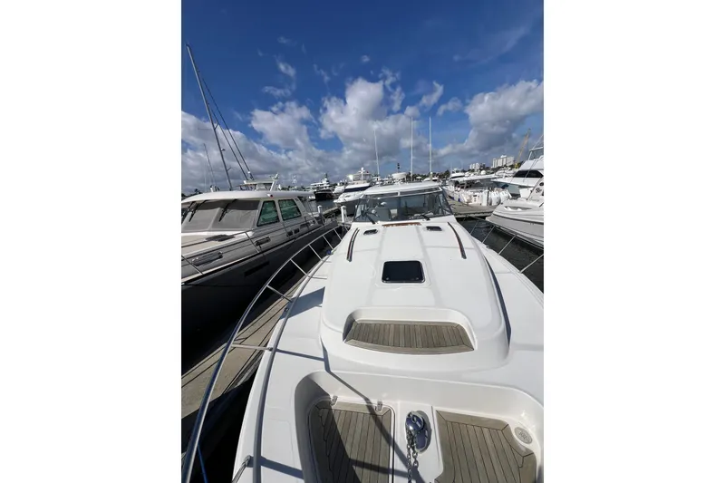 Slide: The Image of 2007 Chris-Craft Roamer 40 yacht docked, showcasing sleek design and polished chrome details. - 24