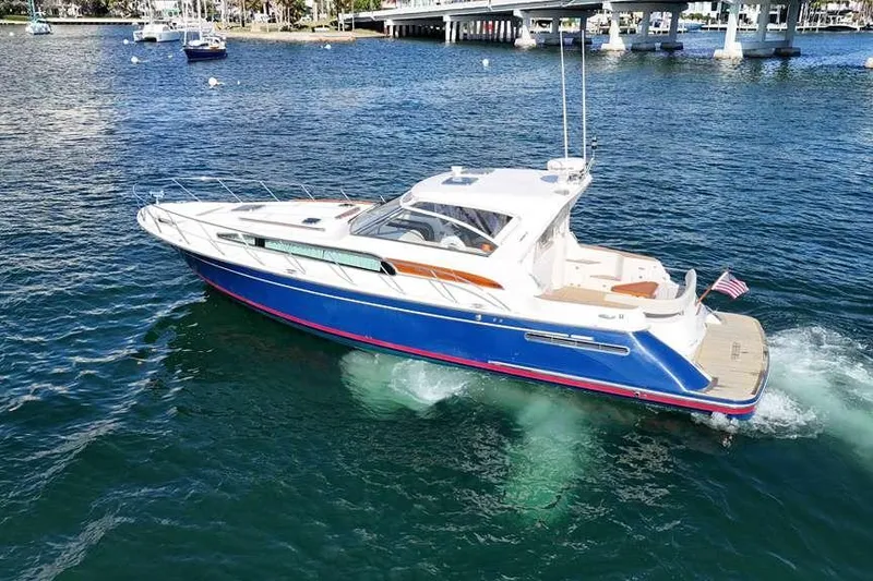 Slide: The Image of 2007 Chris-Craft Roamer 40 yacht cruising under a bridge on a sunny day. - 3