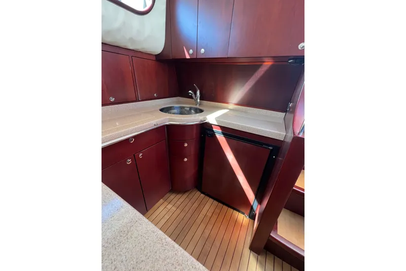 Slide: The Image of Wooden cabinetry and Dometic fridge in 2007 Chris-Craft Roamer 40 yacht interior. - 31