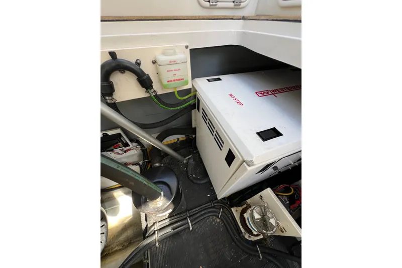 Slide: The Image of Engine compartment of 2007 Chris-Craft Roamer 40 with visible hoses and components. - 47