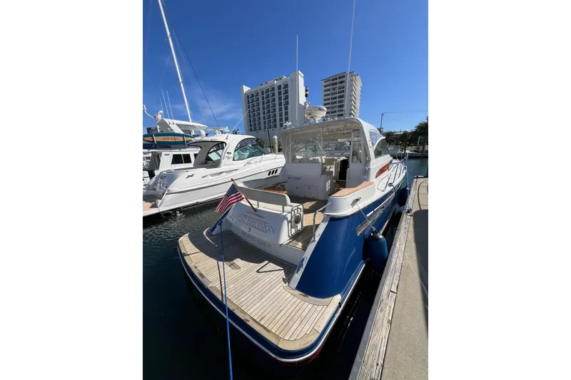 Slide: The Image of 2007 Chris-Craft Roamer 40 yacht docked, featuring elegant design and American flag. - 6