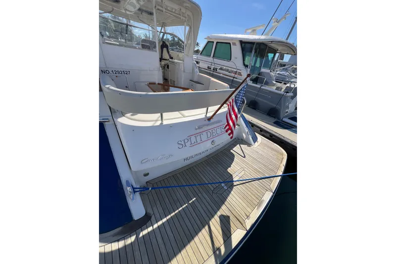 Slide: The Image of 2007 Chris-Craft Roamer 40 yacht docked, displaying American flag and "Split Decision" name. - 7