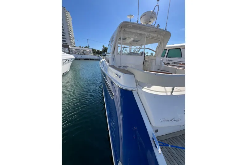 Slide: The Image of 2007 Chris-Craft Roamer 40 yacht docked in marina, featuring sleek blue and white design. - 8