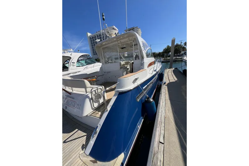 Slide: The Image of 2007 Chris-Craft Roamer 40 yacht docked at marina, featuring sleek design and blue hull. - 9