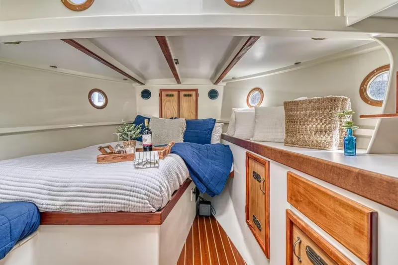 Slide: The Image of Cozy cabin interior of 1996 Devlin 38 boat with bed, pillows, and wooden accents. - 13