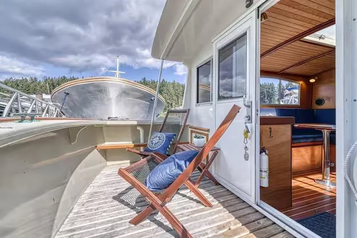 Slide: The Image of Deck view of 1996 Devlin 38 boat with chairs and cabin interior. - 14