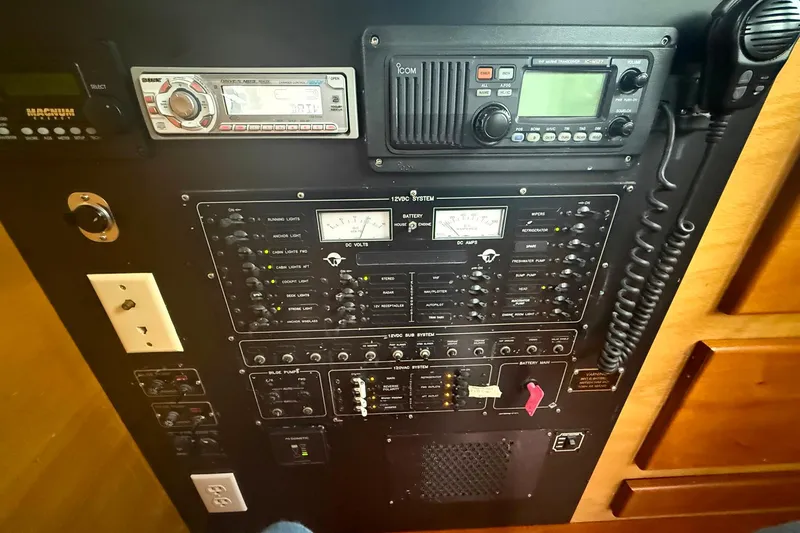 Slide: The Image of Electrical control panel on a 1996 Devlin 38 boat, featuring various switches and gauges. - 19