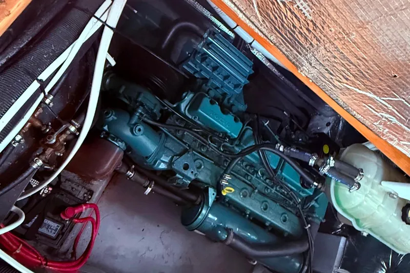 Slide: The Image of Engine compartment of a 1996 Devlin 38 boat, showcasing mechanical components and wiring. - 20