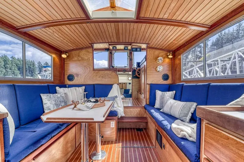 Slide: The Image of Interior of a 1996 Devlin 38 boat with blue seating and wooden accents. - 3