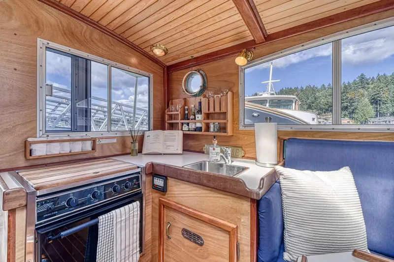 Slide: The Image of Cozy 1996 Devlin 38 boat interior with kitchen, stove, and scenic window views. - 6