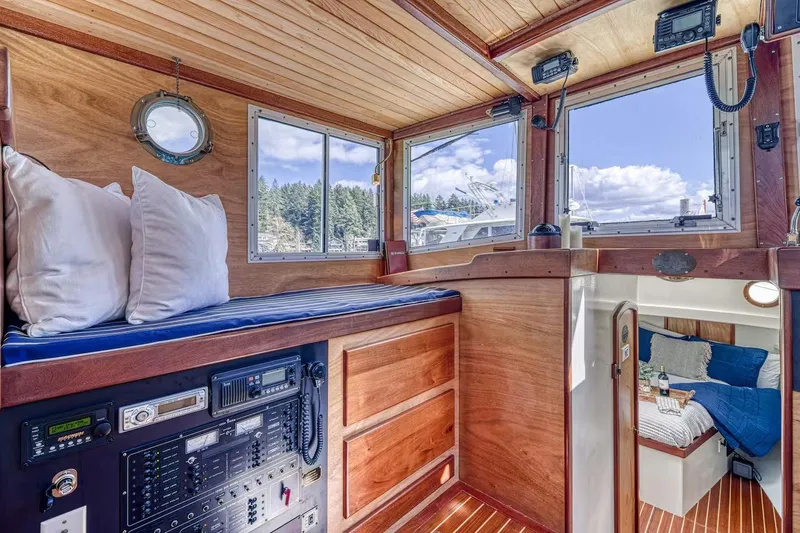 Slide: The Image of Interior of 1996 Devlin 38 boat with wood paneling, navigation equipment, and cozy cabin. - 8