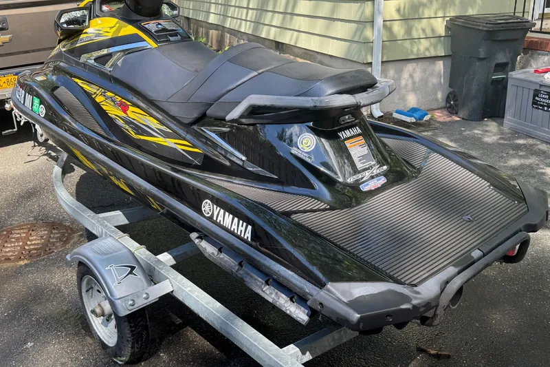Slide: The Image of 2015 Yamaha WaveRunner VXR on trailer, black and yellow design, parked outdoors. - 3