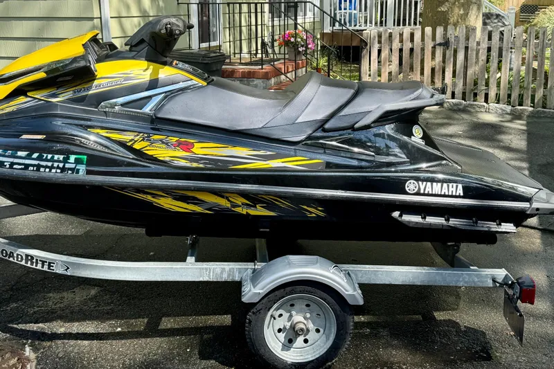 Slide: The Image of 2015 Yamaha WaveRunner VXR on trailer, black and yellow design, parked outdoors. - 5