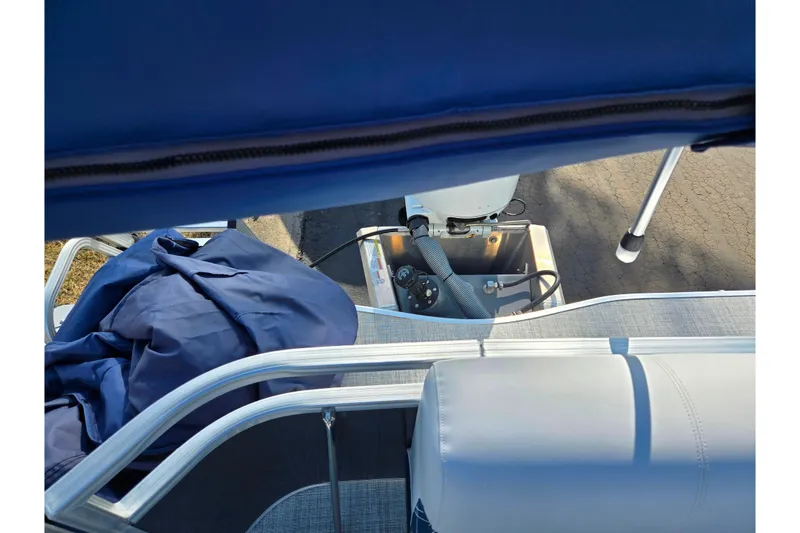 Slide: The Image of 2024 Nepallo 18TL boat interior with blue cover and motor view. - 15