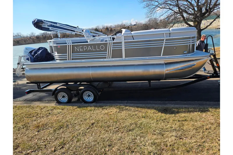 Slide: The Image of 2024 Nepallo 18TL pontoon boat on trailer by a lakeside. - 9