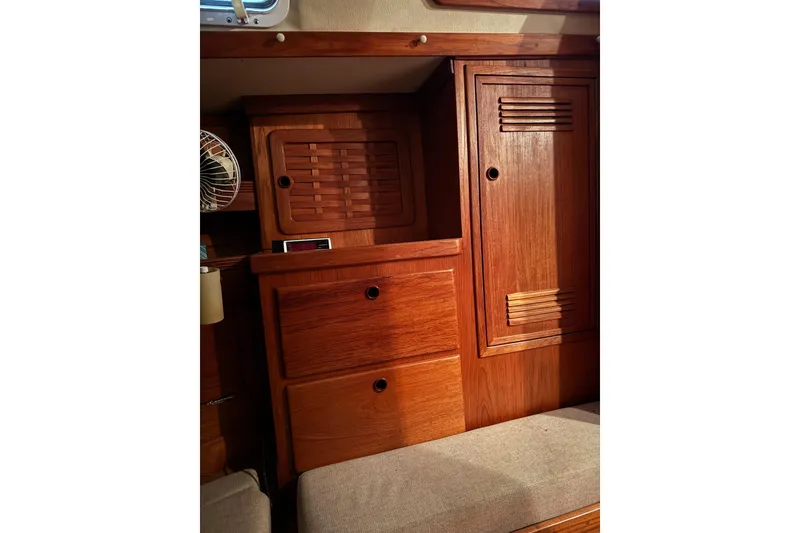 Slide: The Image of Wooden interior of 1988 Sabre 42 yacht, featuring cabinets and drawers. - 10