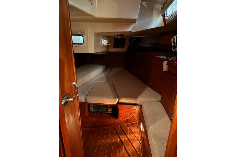 Slide: The Image of Interior cabin of 1988 Sabre 42 sailboat with wooden finish and cushioned seating. - 12