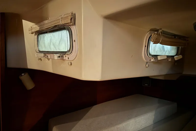 Slide: The Image of Interior cabin of 1988 Sabre 42 sailboat with portholes and bedding. - 13